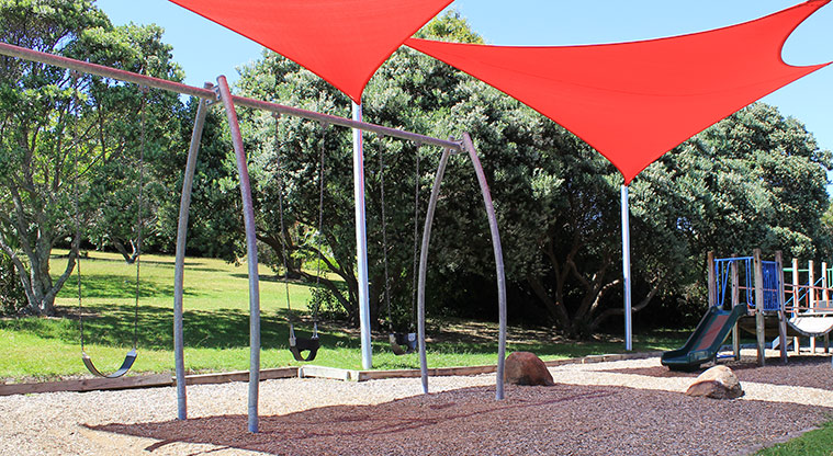 Hardley Reserve - Swings covered by large red shade sails. Photo credit: M Loubser.
