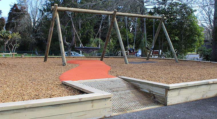 Harold Moody Reserve - Wooden ramp leading to the play area and swing set.