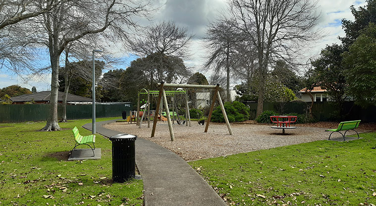 Harwood Reserve - Open grassed area, two seats and the playground. Photo credit: S Hulse.