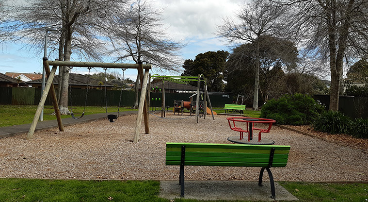 Harwood Reserve - One of the seats and the playground in the background. Photo credit: S Hulse.