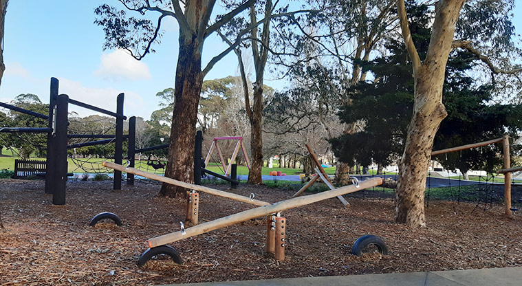 Manu-kau Noa Iho / Hayman Park - Seesaws and climbing equipment under the trees.