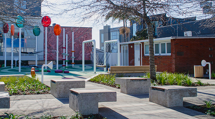 Heard Park - Areas of seating inside the park with the play area in the background.