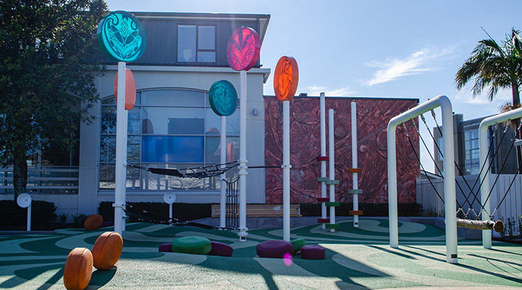 Heard Park - The play area with a log swing, climbing nets, colourful lollipop poles and sound tubes.