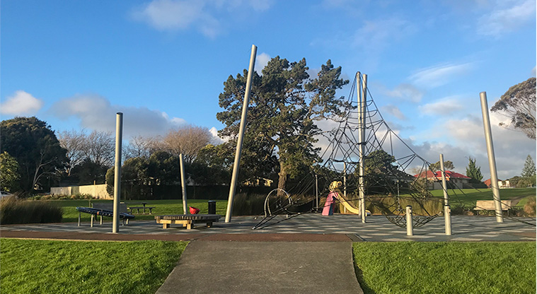 Heron Park - Playground with climbing structure, wooden seat, supernova, slide, spinning bucket and a bucket swing.