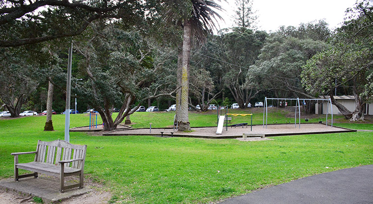 Hinemoa Park - The park with a bench, playground, and toilets in the background. Photo credit: Aleksandar Ćirilović.
