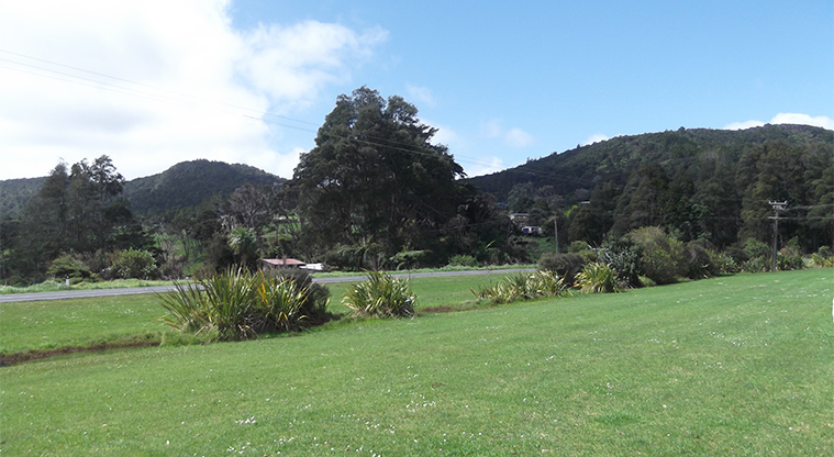 Huai Domain - Open space with Huia Road and hills in the background.