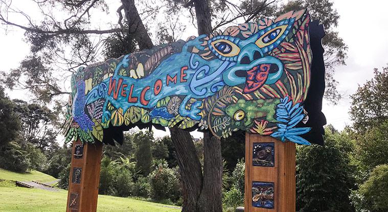 Ōkaurirahi / Kaurilands Domain - Colourful sign at the entrance to the domain.