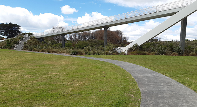 Kukuwai Park - A section of the sports field and path leading to the steps up to the Te Whitinga Bridge.