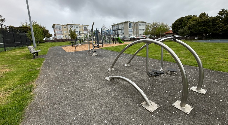 Kupe Reserve - Flat path with fitness equipment, seating and playground in the background.