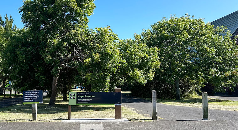 Kupe Reserve - Entrance off Kepa Road with the reserve sign, path and trees in the background. Photo credit: S Hulse.