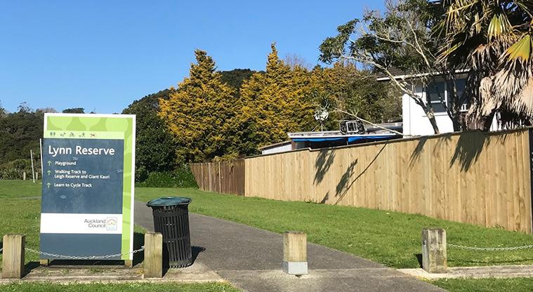 Lynn Reserve - Sign at the main entrance to the reserve, with a path and fence of the right.