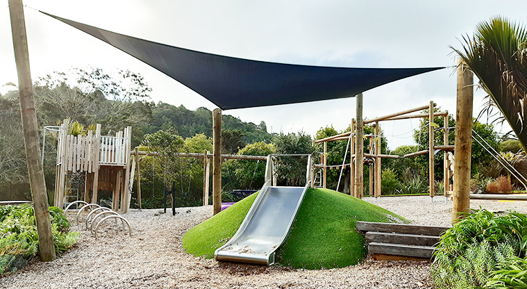 Manuka Reserve - Slide down a green mound with a dark blue shade sail over the top. Photo credit: S Hulse.