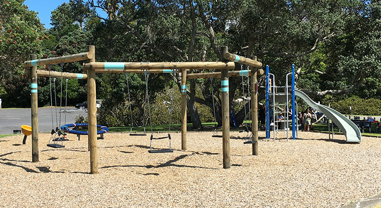 Maraetai Park - Hexagonal swing frame with climbing equipment and the high slide in the background. Photo credit: S Hulse.
