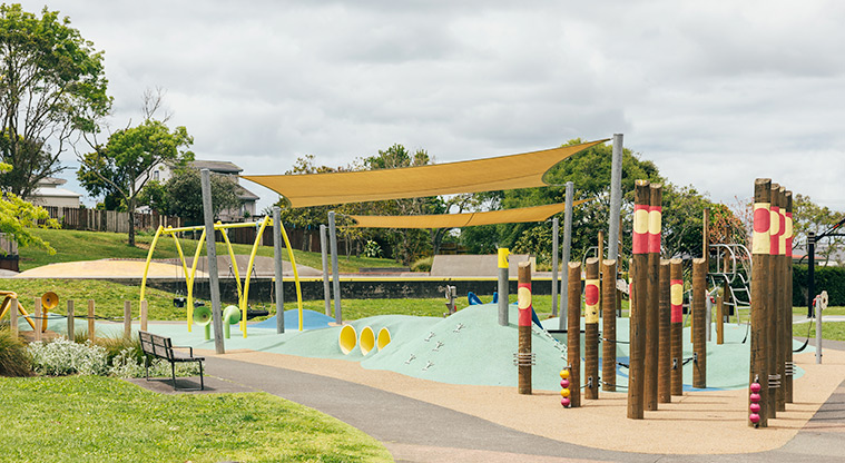 Marlborough Park - Interactive timber play poles with the climbing mound, shade sails and swings in the background. Photo credit: J Farnworth.