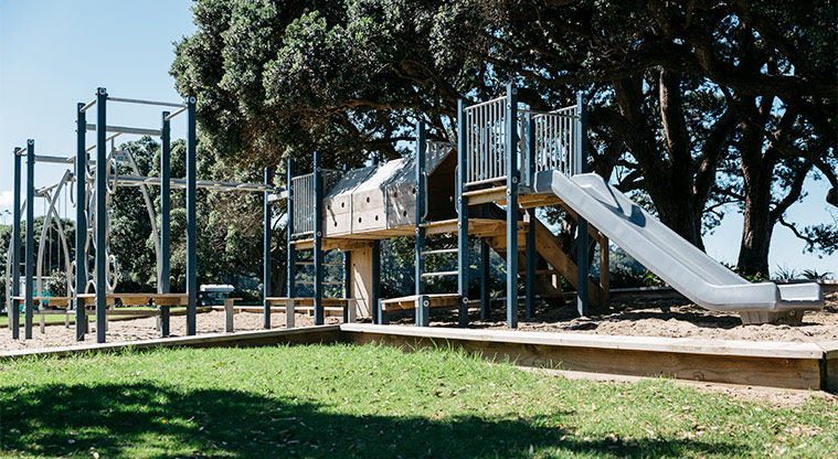 Martins Bay Holiday Park - Playground with climbing equipment, swings, tunnel and slide.