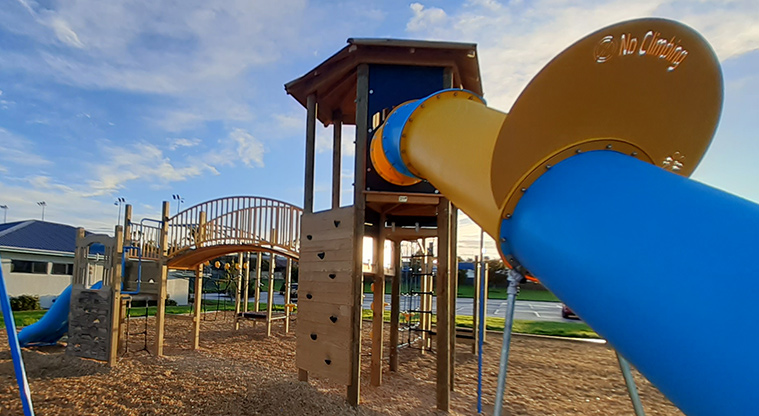 Meadowland Park - View of a section of the playground with climbing walls, play tower, bridge, and part of the large slide.