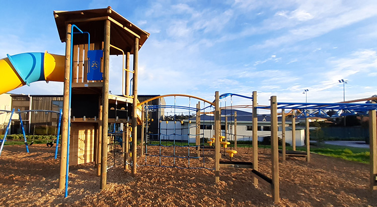 Meadowland Park - View of the playground showing sliding pole from the tower, climbing net, and swinging equipment.
