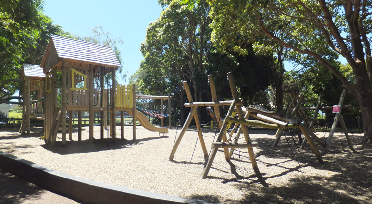 Melville Park - Wooden playground under the trees with climbing nets and towers, platforms, wobbly bridge, and more. Photo credit: J Grigg.