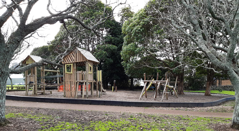 Melville Park - Wooden playground under the trees with climbing nets and towers, platforms, wobbly bridge, and more.