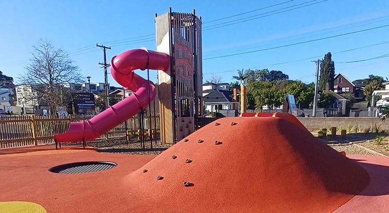 Michaels Avenue Reserve - Climbing mound with the tower and covered slide in the background.