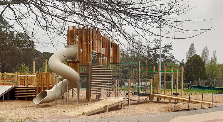 Moire Park - Play module with ramp access, a tall tower, a twisty covered slide and wide slide, wobbly bridge, climbing equipment, and more.