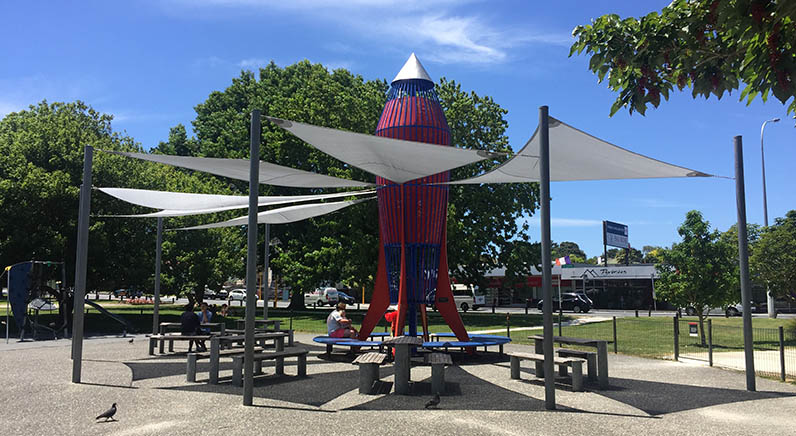 Mt Albert War Memorial Park – The rocket with tables, seating and shade cloth around it.