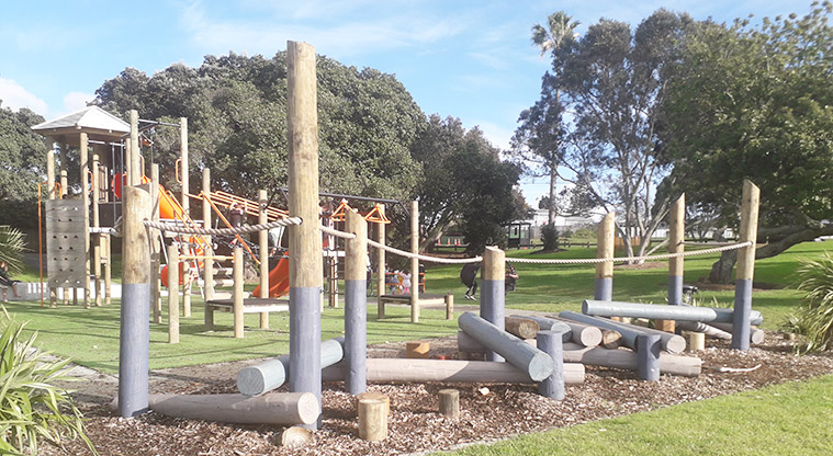 Mt Wellington War Memorial Reserve - Logs for walking along and balance, with the rest of the playground in the background.