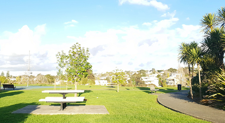 Newmarket Park - Picnic tables and seating, open space and the play area in the background.
