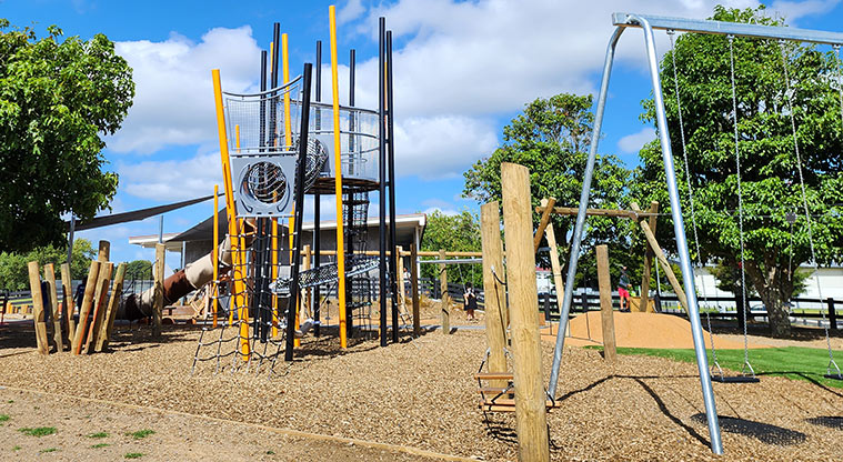Ngāti Ōtara Park - The large climbing tower with a set of swings in the foreground.