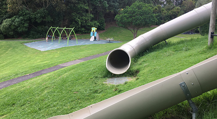 Nixon Park - Looking in the end of the long covered slide, with the junior playground in the background. Photo credit: S Hulse