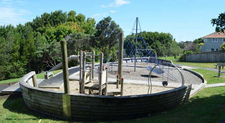 Northboro Reserve - Boat shaped playground with a boardwalk across the middle, small climbing frame, swings and spider web net.