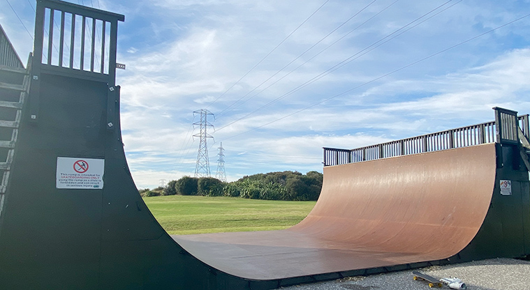 Onehunga Bay Reserve - Wooden half-pipe with open grassed area and trees in the background. Photo credit: J Farnworth