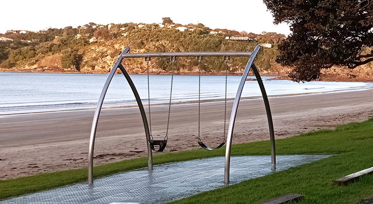 Oneroa Beach Reserve - Swing set with the beach and headland in the background. Photo credit: K Sumner.