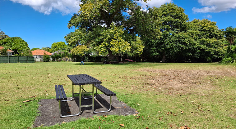 Orchard Reserve - Picnic table with grassed space and trees in the background. Photo credit: T Hodder.