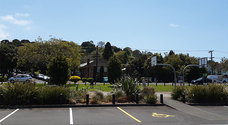 Owairaka Park - Section of the car park showing a mobility parking space and the basketball half-court in the background.