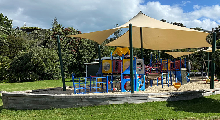 Palm Beach Reserve -Boat shaped play area with a sand base, climbing equipment, swings, slides, spinning egg cup, and more. Shade sails cover the main play area. Photo credit: T Hodder.