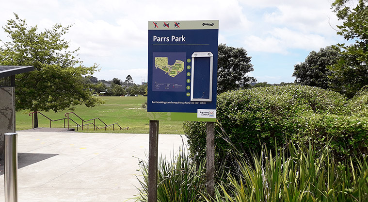 Parrs Park - Sign showing the layout of the park. Steps and grassy slope down to the sports fields in the background.