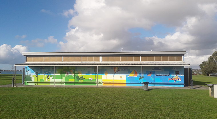 Point England Reserve - Sports and beach themed mural on the front of the toilets and changing rooms building.