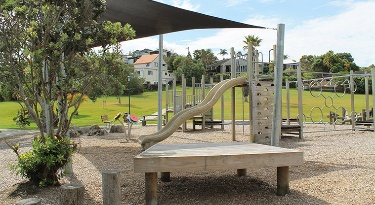 Red Beach Park - Section of the playground showing climbing equipment, slide, spinning toys, seating and shade cloth. Photo credit: M Loubser.