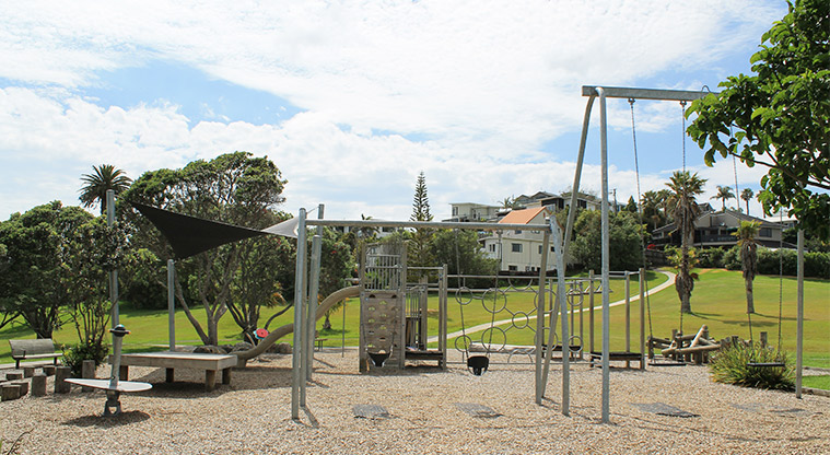 Red Beach Park - Playground with swings, climbing equipment, slide, spinning toys, seating and shade cloth. Photo credit: M Loubser.