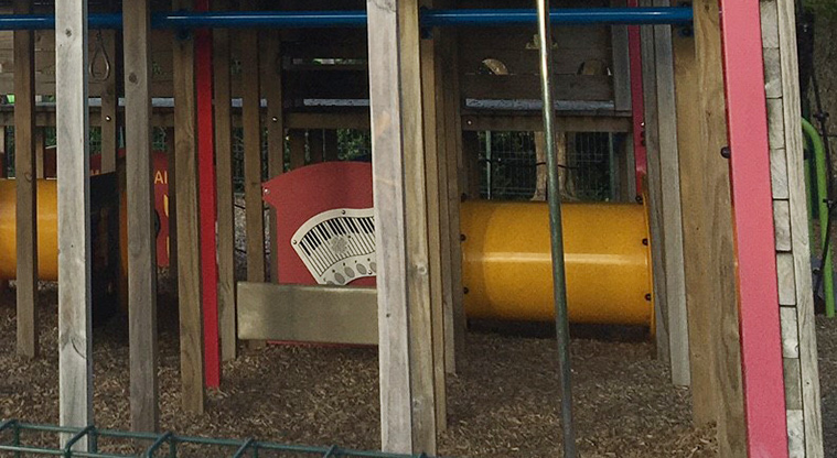 Roberta Reserve - A bright yellow tunnel under the main climbing structure, and a play piano.