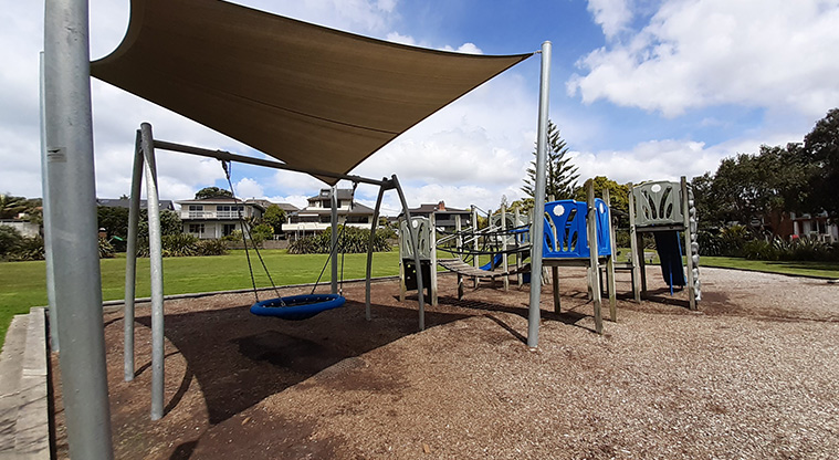 Rothesay Bay Beach Reserve - Playground with a shade sail over the basket swing.