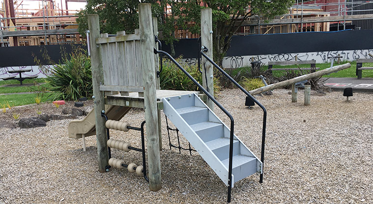 Sainsbury Reserve - Play tower for small children with steps, climbing net and slide, and a seesaw in the background. Photo credit: S Hulse.