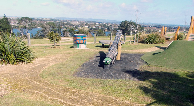 Sanders Reserve - Play equipment with views of the Waitematā Harbour in the background.