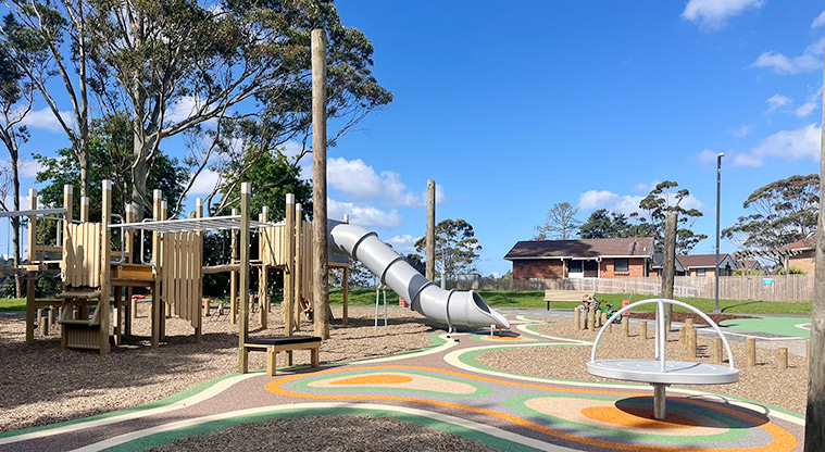 Shepherds Park - Playground with a large play structure, covered slide and spinning carousel.