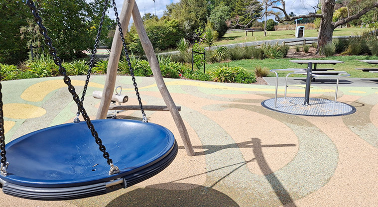 Shoesmith Domain Recreation Reserve - The basket swing with a rocker toy and carousel in the background.