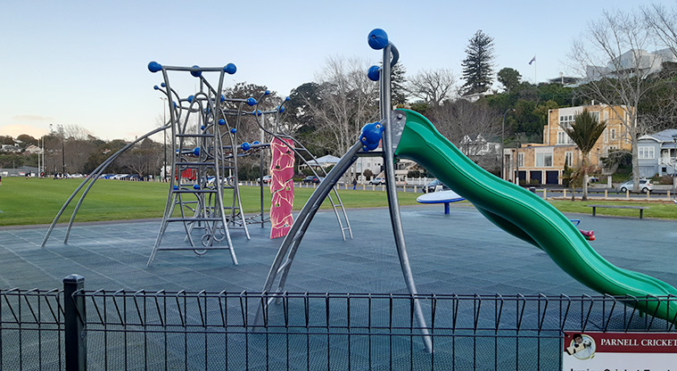 Shore Road Reserve - Section of fence with the slides and climbing structure in the background.