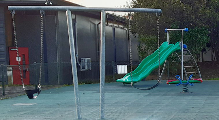 Shore Road Reserve - Set of two swings with the slide and a rocker toy in the background.