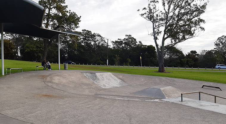 Tiakina / Sister Rene Shadbolt Park - Section of the skate park and shelter with seating.