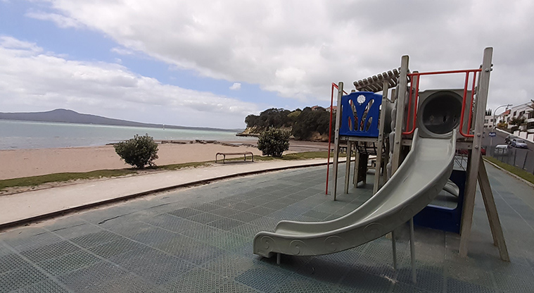 St Heliers Bay Beach Reserve - Curved slide from the play module, with the beach and Rangitoto Island in the distance.